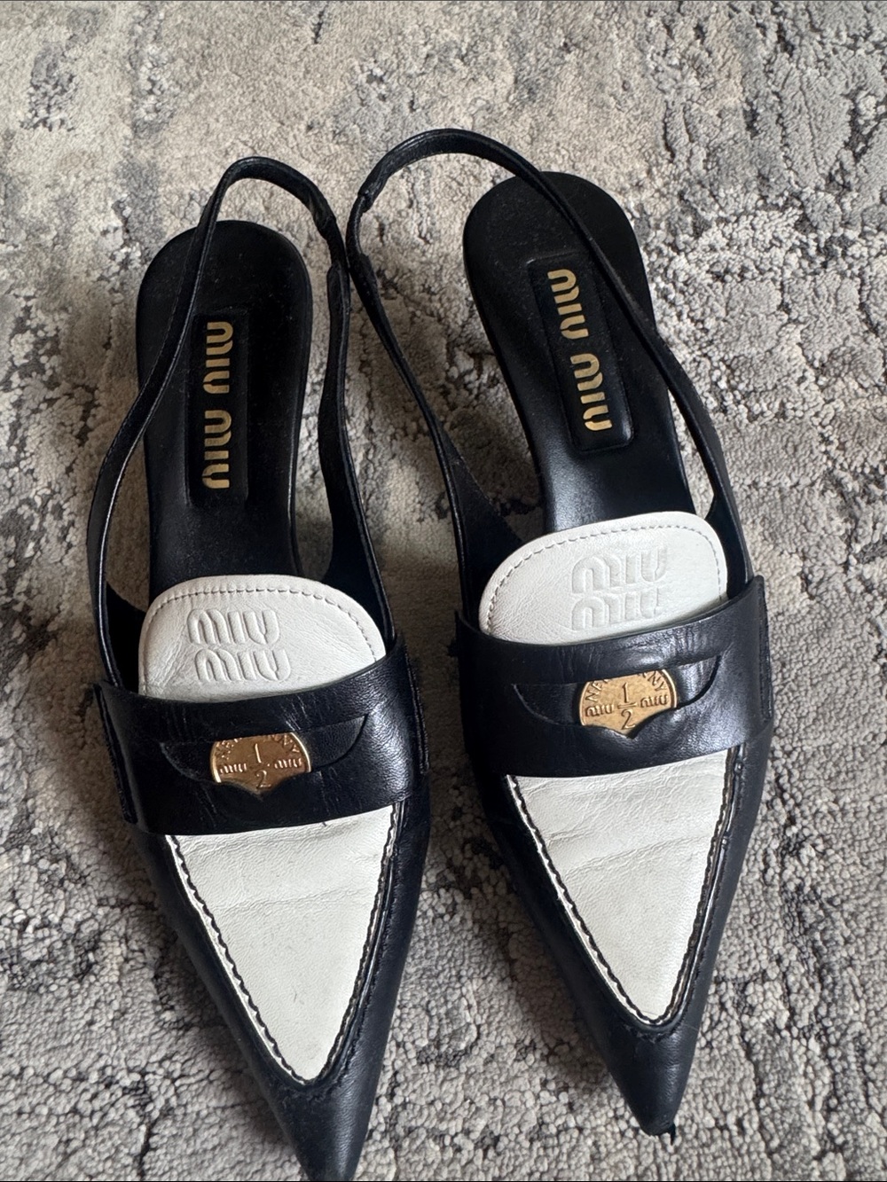 Miu Miu Black & White Pointed Slingback Loafers with Gold Emblem